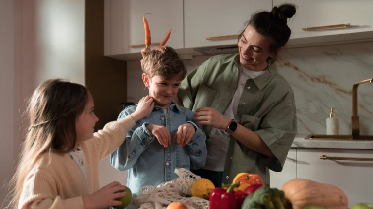 Mother and children have fun unpacking vegetables in the kitchen.