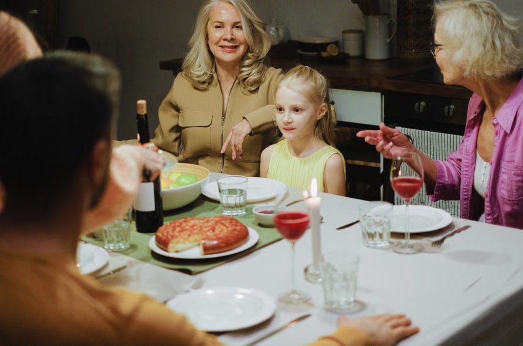 A multigenerational family enjoying dinner together at home, highlighting family bonds and togetherness.
